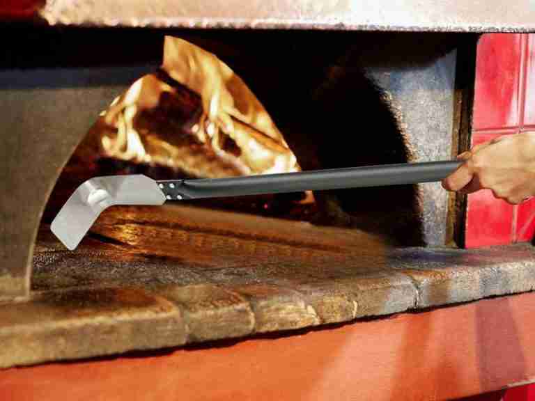 cleaning a pizza oven with the ash tool