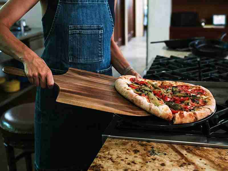 woman using a pizza peel