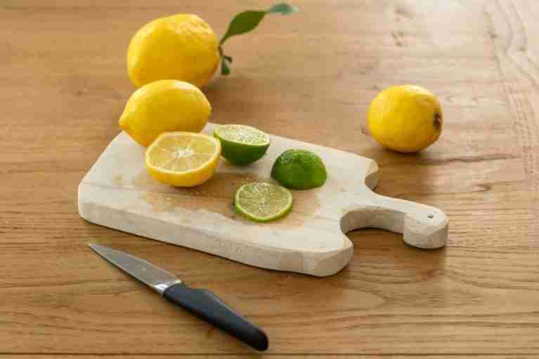 wooden cutting board with lemons on it