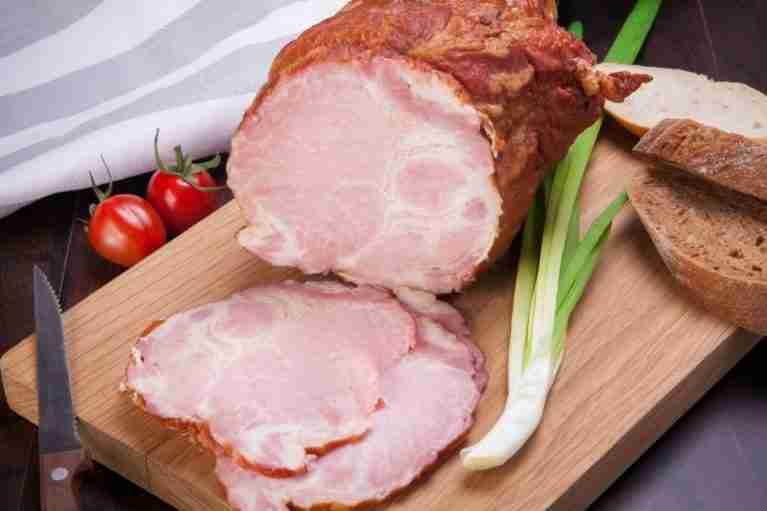 sliced ham on a wooden cutting board