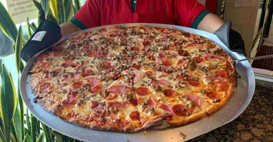 Big Pizza at man hands